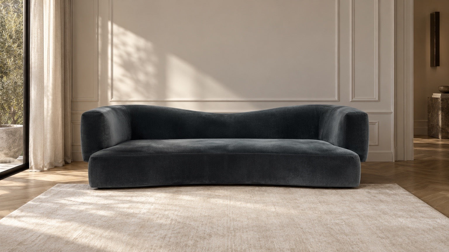 La Vague sofa in Abysse petrol blue velvet in a panelled living room with linen curtains and a garden window, Dubai, Saint Objets