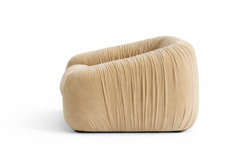 Aphrodite armchair in beige velvet, gathered by hand, side view on white